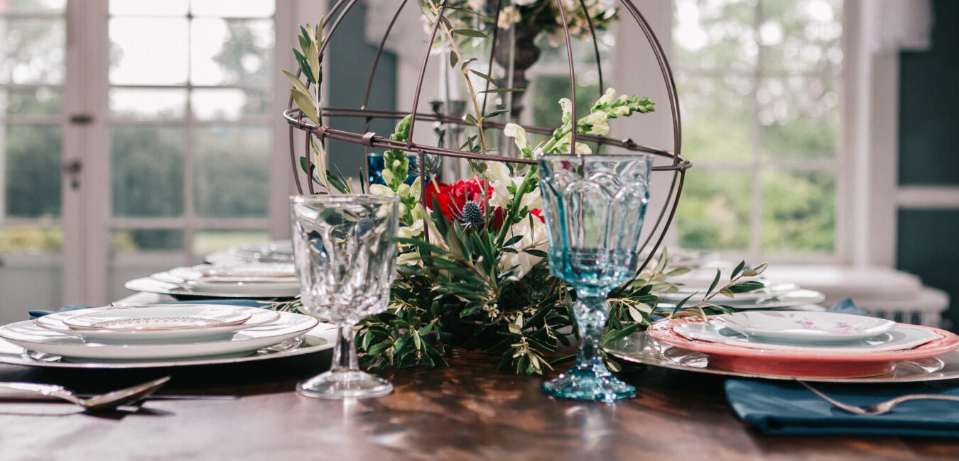 Bleak House photoshot with blush, navy, and scarlet table setting inspiration for fairytale chic events