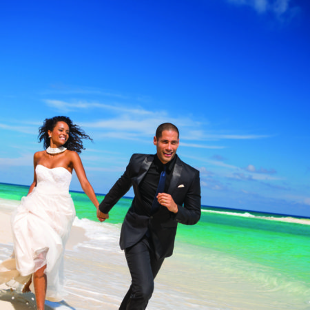 Bridal couple on beach at Sandals